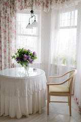 a bouquet of lilacs on the table in the room
