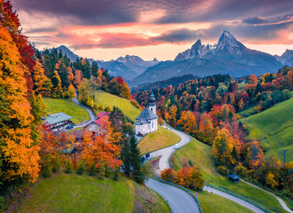 View from flying drone of Maria Gern church with Hochkalter peak on background. Splendid autumn sunset on Bavarian Alps. Colorful evening landscape of Germany countryside.