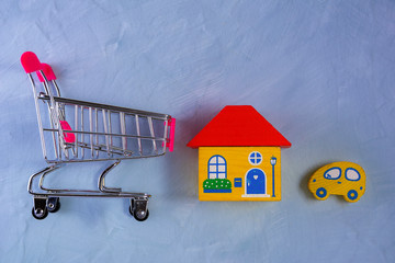 concept of buying a home and car, grocery cart