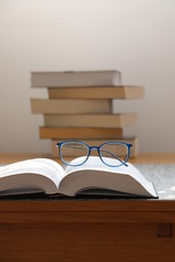 reading books and glasses - obrazy, fototapety, plakaty