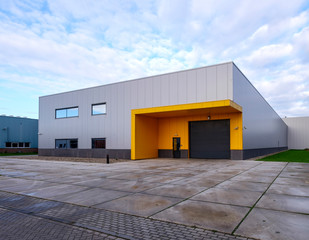 Outside view of a small, empty warehouse in an industrial area