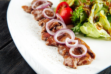 Gourmet cooked beef meat sauce onion ring salad 