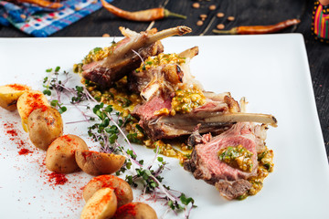 Closeup on gourmet fried lamb chops with sauce