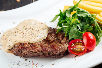 Beef steak under the mushroom cream sauce salad