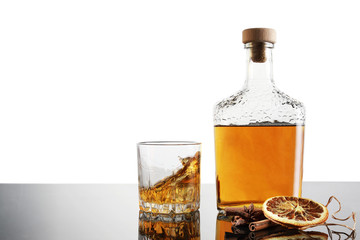 Whiskey bottle and whiskey glass with ice isolated on white background with copy space.
