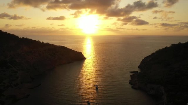 Aerial view of Cala Llonga beach, located in southern Ibiza, Spain. Beautiful aerial view of the bay at sunset