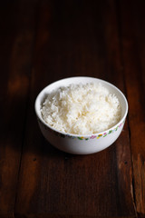 Cooked Thai jasmine rice on wooden background - vintage filter