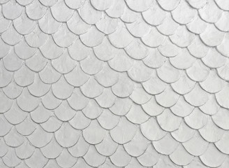 White color fish scale mortar plastering pattern on skin of wall in vintage old style © Arunee