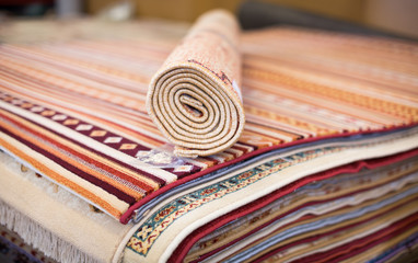 Assortment of colour carpets in the store