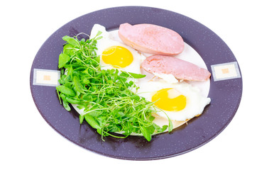 Fried eggs, sausages, fresh green salad, breakfast.