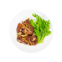 Pieces of fried liver with onions, fresh leaves of salads