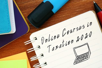 Business concept about Online Courses In Taxation 2020 with inscription on the sheet.