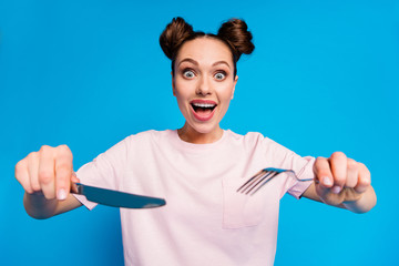 Photo of pretty funny hungry lady two funny buns hold metal fork knife wait tasty meal cutting...
