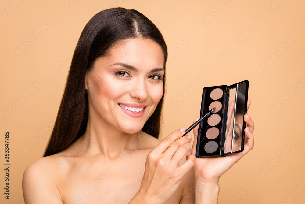 Wall mural closeup photo of mature latin naked lady in bathroom holding tone palette applicator going to make m