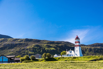 Fototapeta na wymiar Alnes lighthouse at clear sumer sky at Godoy island near Alesund, Norway