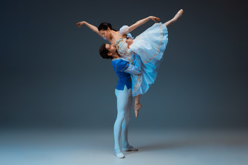 Young and graceful ballet dancers as Cindrella fairytail characters on studio background. Art, motion, action, flexibility, inspiration concept. Flexible caucasian ballet dancers in inspired dancing.