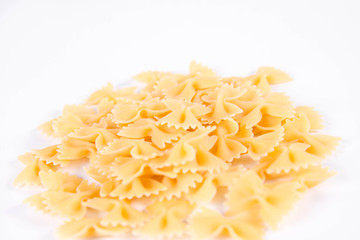 Raw Farfalle pasta on a white background