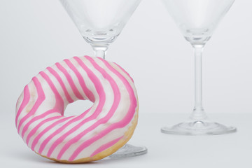  Martini glass and pink donut. Close-up. - 353353184