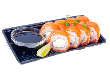 Black plate with rolls with salmon and soy sauce, Japanese cuisine