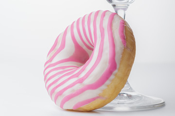  Martini glass and pink donut. Close-up. - 353353736
