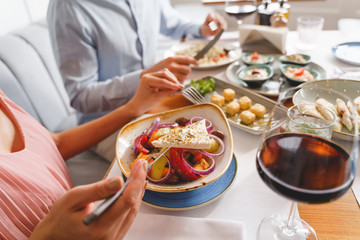 Young woman and man having lunch in restaurant