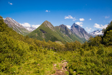 On top of the summit of Mount with incredible views of the Sunnmore Alps in Norway