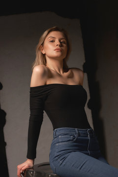Woman in black top and jeans