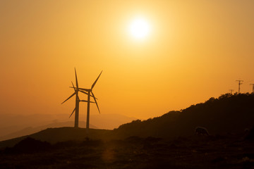 wind generators at sunset