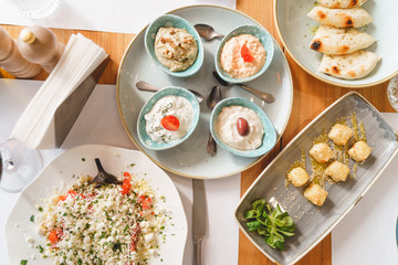 Wooden cafe table with different cooked dishes