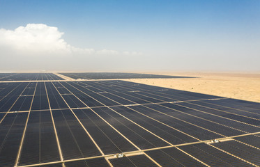 Aerial view of a landscape with photovoltaic solar panel farm generating sustainable renewable...