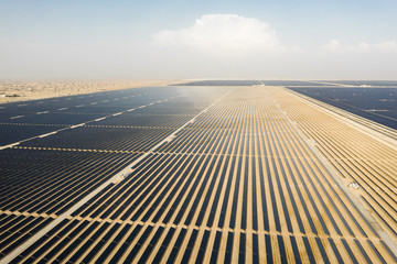 Aerial view of a landscape with photovoltaic solar panel farm producing sustainable renewable...