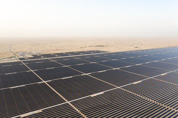 Aerial view of a landscape with photovoltaic solar panel farm generating sustainable renewable...