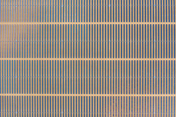 Vertical aerial view of a photovoltaic solar panel farm producing sustainable renewable energy in a desert power plant.
