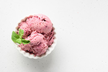 Homemade berries ice cream in metal container on white background. View from above. Clean eating. Without sugar.