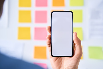 Smartphone mock-up. Web designer, UX specialist looking at empty smartphone screen