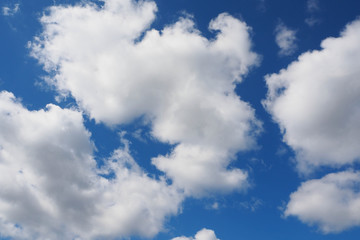 white clouds against a blue sky on a summer day . sky background