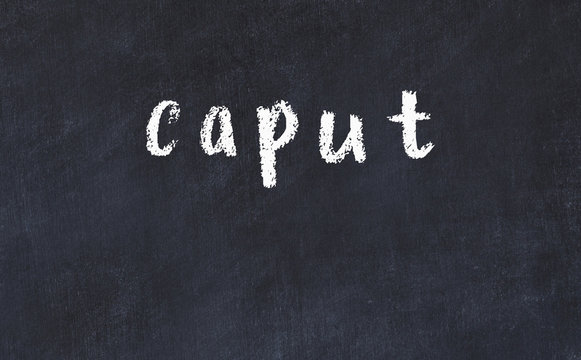 College chalk desk with the word caput written on in