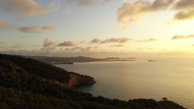 Aerial view of Cala Llonga beach, located in southern Ibiza, Spain. Beautiful aerial view of the bay at sunset