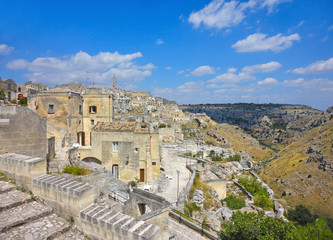 Fototapeta na wymiar Panoramic view of the ancient town of Matera (Sassi di Matera), European Capital of Culture 2019,and UNESCO Heritage site with blue sky and clouds, Basilicata, southern Italy 