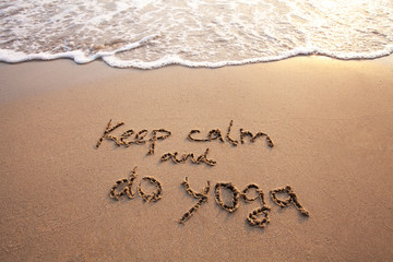 keep calm and do yoga, text on sand