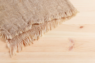 Jute sack on wooden background.