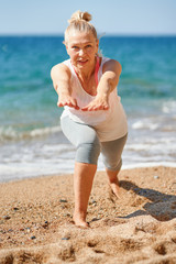 Adult attractive woman during sports by the sea
