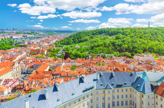 Top aerial panoramic view of Prague historical city centre with red tiled roof buildings in Mala Strana Lesser Town and Smichov district, Vrtba Garden on slope of Petrin Hill, Bohemia, Czech Republic