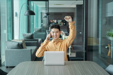Portrait of happy smiling young business Asian, Chinese man person using laptop computer, working,...
