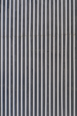 Wall background of vertical metal lines in industrial style