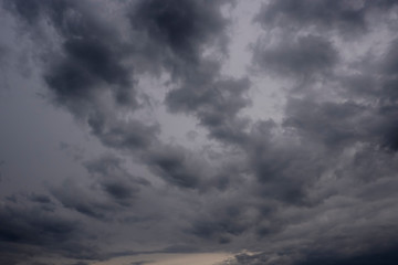 A gloomy dark sky at evening sunset with storm clouds. Beautiful cloud landscape.