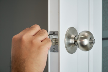 home service concept by locksmith repair silver knob with screwdriver