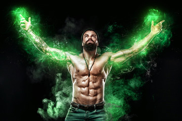 Fototapeta na wymiar Athlete in green energy lights. Bodybuilder posing. Beautiful sporty guy male power. Fitness muscled man. Spot and bodybuilding concept