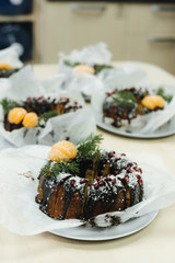 christmas cake with decorations of Christmas trees and tangerine