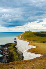 Seven sisters cliffs on the cloudy day. Deep blue sea and chalk cliffs in the summer. England.